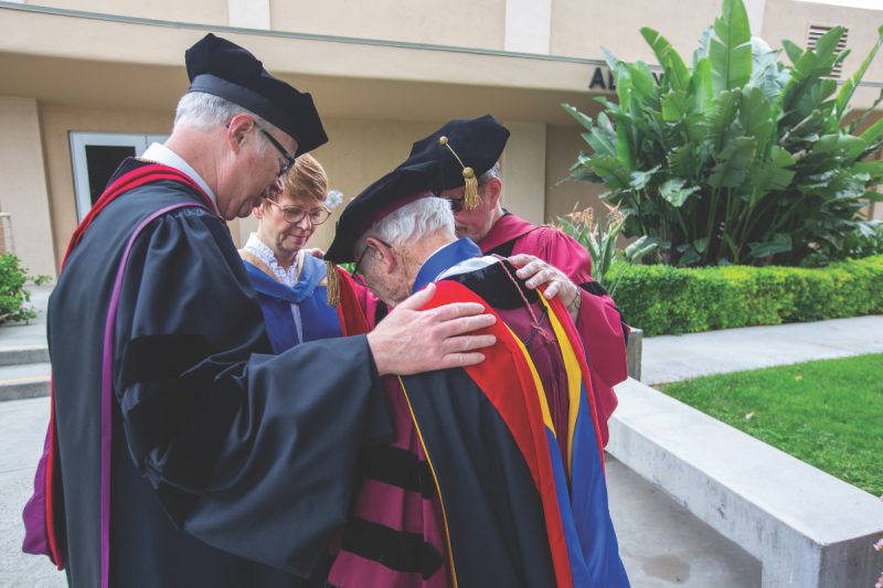he university’s current president and former presidents gather in prayer in June 2019.