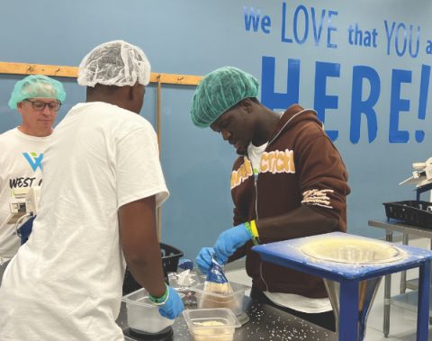  SECC youth pack food during a community service project.