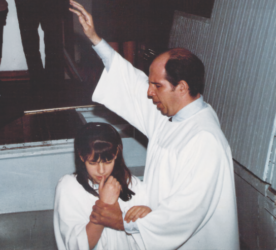 Liss’ father Roman Leal baptizes her at the age of 9.