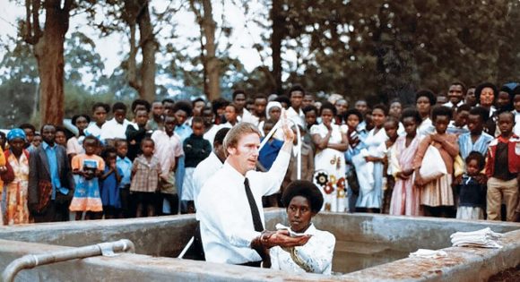 While serving as a missionary in Kenya, Pastor Jim Kilmer baptizes one of the University of Eastern Africa's students.