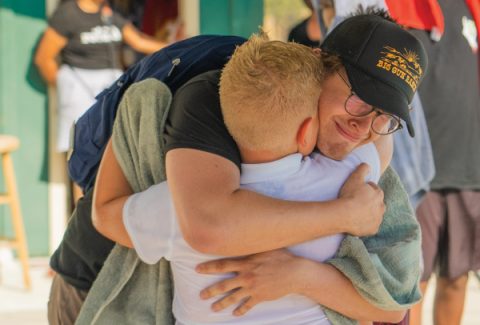 PSR Camp staff alum Wills Groth hugs his brother, Levi, after he is baptized.