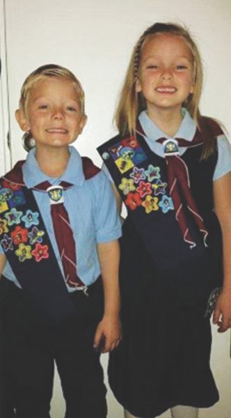 Micah and Eriana Washburn, the charter members of the West Jordan Wildfire Adventurer Club, proudly wear their uniforms and display the multiple honors they have earned.